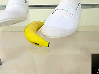 Japanese asian girl performs food crush fetish by crushing a banana
