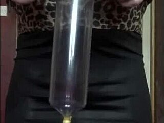 Bisexual crossdresser in stockings swallows pee from tube