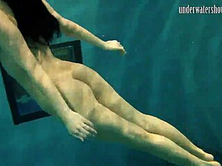 brunette babe poses erotically underwater in swimming pool