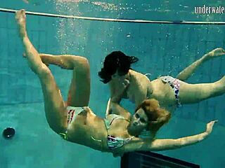 brunette babe poses erotically underwater in swimming pool