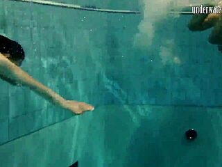 brunette babe poses erotically underwater in swimming pool