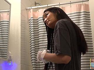 Beautiful woman dyes her hair black in front of mirror