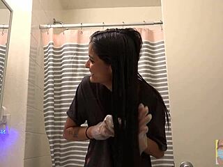 Beautiful woman dyes her hair black in front of mirror