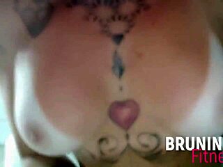 the athletic redhead pornstar with big tits and tattoos dances reggaeton, shaking her tanned ass seductively.