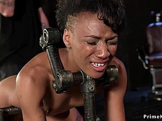 Slim ebony feels intense pleasure in device bondage.