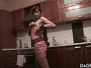 The freckled-face babe in Dagfs undresses on kitchen counter, using dildo and banana for striptease.