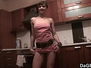 The freckled-face babe in Dagfs undresses on kitchen counter, using dildo and banana for striptease.