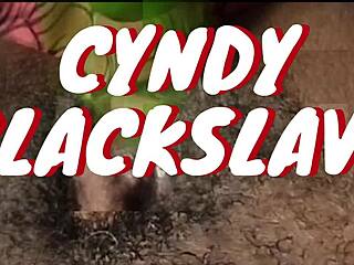 Close up of Cyndy, a black slave, as she squirts while being fucked with a cucumber on webcam.