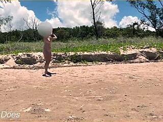 Naked wife enjoys a game of football at a public beach with clothed strangers