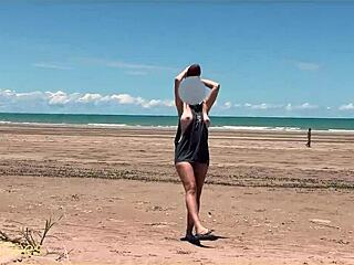 Naked wife enjoys a game of football at a public beach with clothed strangers