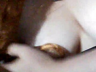 Face mask covers mouth during black dildo play.