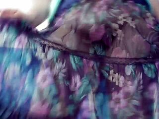 hairy mature woman in a see-through dress outdoors