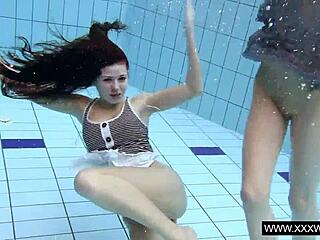 Shaved brunette babe with big tits bathing underwater