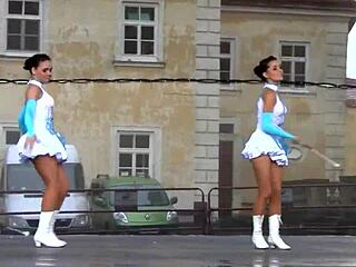 Two nice majorettes perform in cheerleader uniforms