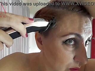 Regina Noir, a naked nudist hairdresser, skillfully cuts her own hair on the beach.