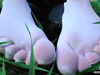 Goddess Feet In Cute White Socks With Jeans On Spring Grass Field