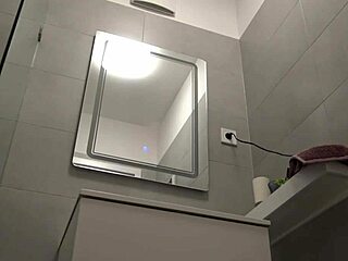 Hottest redhead strips in bathroom, removing t-shirt and panties to reveal tight ass and pussy beautifully.