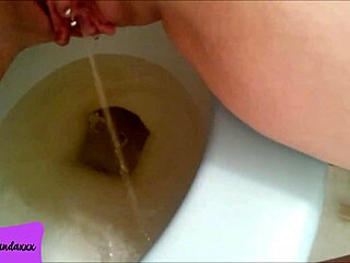 i love showing off my shaved pierced pussy while peeing in the bathroom