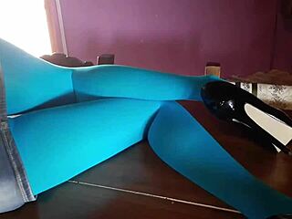 milf with beautiful legs in pantyhose and heels lying on the desk